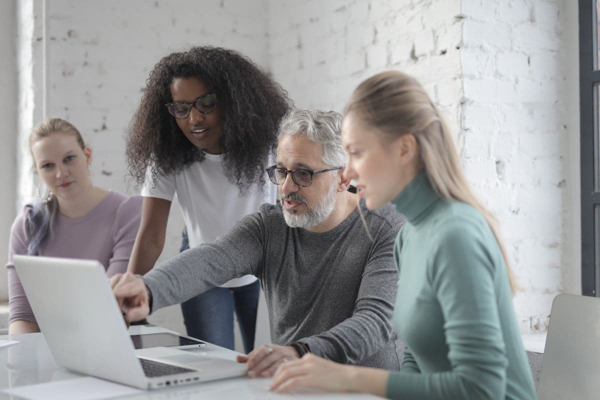 Researchers collaborating around a laptop